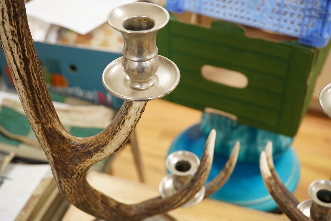 A pair of three light antler candlesticks, 67cm high